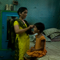 After finishing work, Simmi, a Pathshala student from Geneva Camp, spends time with her mother.